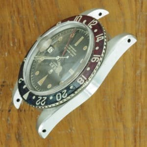 Left side of S/Steel Rolex GMT-Master tropical dial 6542 from 1958