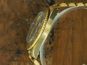 Left side of 1971 18K Rolex brown matte dial GMT-Master ref 1675