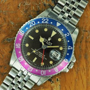 Full front face of 1966 S/Steel Rolex tropical gilt/fuchsia GMT-Master ref 1675