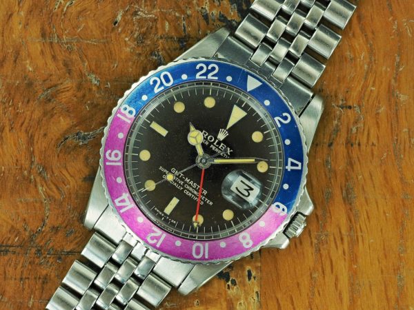 Full front face of 1966 S/Steel Rolex tropical gilt/fuchsia GMT-Master ref 1675