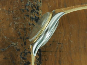 Left side of 1953 S/Gold Rolex Datejust big bubble back ref 6105
